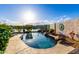 The backyard features a private pool area with beautiful landscaping and serene lake views at 16226 S 11Th Pl, Phoenix, AZ 85048