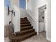 Carpeted staircase with a laundry area featuring a modern washer and dryer, and white walls at 16226 S 11Th Pl, Phoenix, AZ 85048