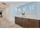 Upstairs hallway featuring a convenient built-in counter and cabinets, plus bright, natural light at 16377 W Weeping Willow Rd, Surprise, AZ 85387