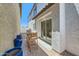 Cozy outdoor patio with seating, a sliding glass door, and potted plants at 16377 W Weeping Willow Rd, Surprise, AZ 85387
