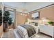 Stylish bedroom with a modern chandelier, neutral color palette, and comfortable furnishings at 16842 W Bronco Trl, Surprise, AZ 85387