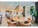 Cozy dining area with a round wooden table, stylish chairs, and a decorative pendant light at 16842 W Bronco Trl, Surprise, AZ 85387