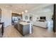 Open kitchen with a large island, stainless steel appliances, and stylish pendant lighting at 16842 W Bronco Trl, Surprise, AZ 85387