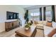 Comfortable living area with modern furniture, large windows, and a contemporary entertainment center at 16842 W Bronco Trl, Surprise, AZ 85387