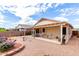 Expansive backyard features a covered patio and a rock garden with vibrant, decorative plants at 18031 W Udall Dr, Surprise, AZ 85374