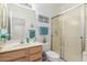 Well-lit bathroom with a single sink vanity and a separate shower, offering both functionality and comfort at 18031 W Udall Dr, Surprise, AZ 85374