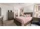 Spacious bedroom with a queen-size bed, soft carpet, and neutral-toned walls creating a cozy ambiance at 18031 W Udall Dr, Surprise, AZ 85374