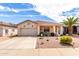 Charming single-story home with stucco siding, tile roof, desert landscaping, and covered front porch at 18031 W Udall Dr, Surprise, AZ 85374