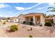 Attractive single-story home featuring desert landscaping, a covered porch, and a welcoming facade at 18031 W Udall Dr, Surprise, AZ 85374
