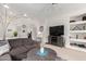 Open-concept living room showcasing plush seating, a ceiling fan, and stylish decor at 18031 W Udall Dr, Surprise, AZ 85374