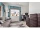Inviting home office with natural light, a comfortable sofa, and practical storage solutions at 18031 W Udall Dr, Surprise, AZ 85374