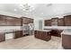 Spacious kitchen features granite countertops, stainless steel appliances, dark wood cabinetry and tiled floors at 18640 W Pioneer St, Goodyear, AZ 85338