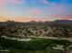 Scenic aerial view of the golf course community with mountain views at sunset in Scottsdale, Arizona at 20750 N 87Th St # 2038, Scottsdale, AZ 85255