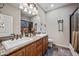 Bathroom with double sinks, granite countertops, decorative tile flooring, decorative accessories, and dark wood cabinetry at 20750 N 87Th St # 2038, Scottsdale, AZ 85255