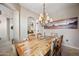 Bright dining room features rustic wood table, unique chandelier, and desert landscape art at 20750 N 87Th St # 2038, Scottsdale, AZ 85255