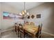 Cozy dining area featuring a rustic wood table, chandelier, and nature artwork at 20750 N 87Th St # 2038, Scottsdale, AZ 85255