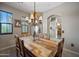 Inviting dining room with rustic wood table, eye-catching chandelier, and natural light from windows at 20750 N 87Th St # 2038, Scottsdale, AZ 85255