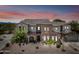 Two-story home boasting a tile roof, stone accents, and a well-maintained front yard under a beautiful sunset sky at 20750 N 87Th St # 2038, Scottsdale, AZ 85255