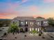 Two-story home boasting a tile roof, stone accents, and a well-maintained front yard under a beautiful sunset sky at 20750 N 87Th St # 2038, Scottsdale, AZ 85255