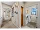 Hallway with laundry room access, offering built-in storage, neutral walls, carpet, and sconce lighting at 20750 N 87Th St # 2038, Scottsdale, AZ 85255