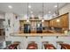 Charming kitchen offers granite countertops, updated appliances, and a breakfast bar with pendant lighting at 20750 N 87Th St # 2038, Scottsdale, AZ 85255