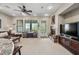 Cozy living room offers a fireplace, neutral carpet, and access to the outdoor patio at 20750 N 87Th St # 2038, Scottsdale, AZ 85255