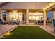 This backyard features outdoor seating, artificial grass, and a covered patio at 21127 W Minnezona Ave, Buckeye, AZ 85396