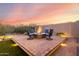 Beautiful backyard featuring a modern fire pit surrounded by comfortable seating and manicured landscaping at 21127 W Minnezona Ave, Buckeye, AZ 85396