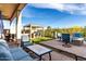 Spacious backyard offering a luxurious outdoor kitchen, comfortable lounge area, and cozy fire pit at 21127 W Minnezona Ave, Buckeye, AZ 85396
