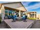 Spacious backyard features a modern fire pit, stylish seating, and a beautiful outdoor entertainment area at 21127 W Minnezona Ave, Buckeye, AZ 85396
