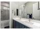 This bathroom features double sinks with a walk-in shower and a large mirror at 21127 W Minnezona Ave, Buckeye, AZ 85396