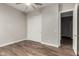 Bedroom features wood floors, neutral walls, sliding closet doors, and a ceiling fan at 21127 W Minnezona Ave, Buckeye, AZ 85396