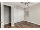 This bedroom features a closet, wood floors, and a modern ceiling fan at 21127 W Minnezona Ave, Buckeye, AZ 85396
