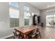 Bright dining room with a large wooden table, chairs, and great natural light at 21127 W Minnezona Ave, Buckeye, AZ 85396
