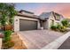 A single-story home with a spacious driveway, two-car garage, and professionally landscaped yard at 21127 W Minnezona Ave, Buckeye, AZ 85396