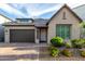 Inviting home exterior with a brick driveway, lush landscaping, and a two-car garage at 21127 W Minnezona Ave, Buckeye, AZ 85396