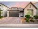 Charming single-story home with a two-car garage, a tile roof, and landscaped front yard at 21127 W Minnezona Ave, Buckeye, AZ 85396