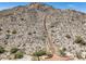 Scenic mountain view showcases an inviting hiking trail with steps leading to the summit, surrounded by desert vegetation at 21127 W Minnezona Ave, Buckeye, AZ 85396