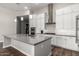 Contemporary kitchen boasts white cabinets, a large island, and stainless steel appliances at 21127 W Minnezona Ave, Buckeye, AZ 85396