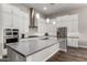 Modern kitchen featuring white cabinets, stainless steel appliances, and a large center island at 21127 W Minnezona Ave, Buckeye, AZ 85396