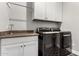 This laundry room features a washer and dryer, countertop, and white cabinetry at 21127 W Minnezona Ave, Buckeye, AZ 85396