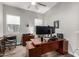 This office features hardwood floors, a modern desk, and natural light at 21127 W Minnezona Ave, Buckeye, AZ 85396