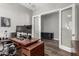 This office features hardwood floors, a modern desk, and glass panel doors at 21127 W Minnezona Ave, Buckeye, AZ 85396