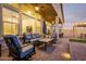 Relaxing outdoor patio with a comfortable lounge area, stylish furniture, and seamless indoor-outdoor living at 21127 W Minnezona Ave, Buckeye, AZ 85396