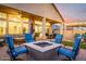 Inviting outdoor patio with a cozy fire pit, comfortable seating, and outdoor dining area at 21127 W Minnezona Ave, Buckeye, AZ 85396