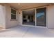 Covered back patio with a view through the sliding glass door to the kitchen and the home interior at 2205 S 241St Dr, Buckeye, AZ 85326