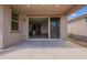 Covered back patio and sliding glass door leads to the home interior at 2205 S 241St Dr, Buckeye, AZ 85326