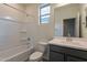 Clean bathroom with a tub-shower combination and a modern vanity with gray cabinets at 2205 S 241St Dr, Buckeye, AZ 85326