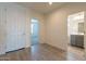 Entryway featuring wood-look tile, and doorway views to bath and bedroom, with front door view at 2205 S 241St Dr, Buckeye, AZ 85326