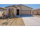 Charming single-story home featuring desert landscaping, a two-car garage, and a welcoming front entrance at 2205 S 241St Dr, Buckeye, AZ 85326